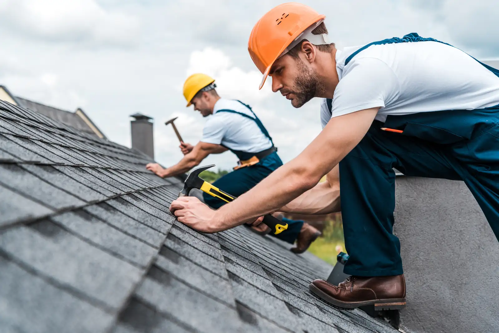 Roofer fixing a roof on a sunny day