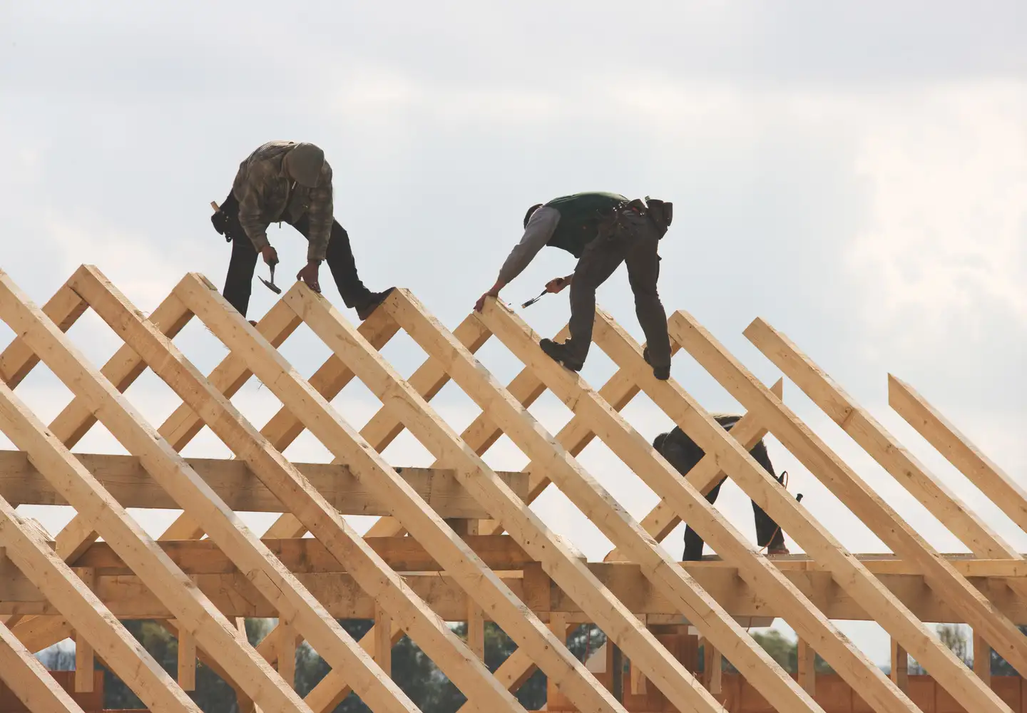 Roofers at work on a roof under construction