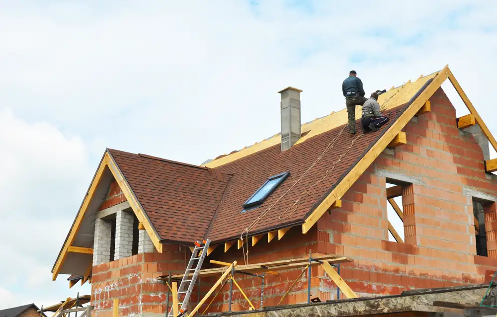 Roofers working on the roof of a house
