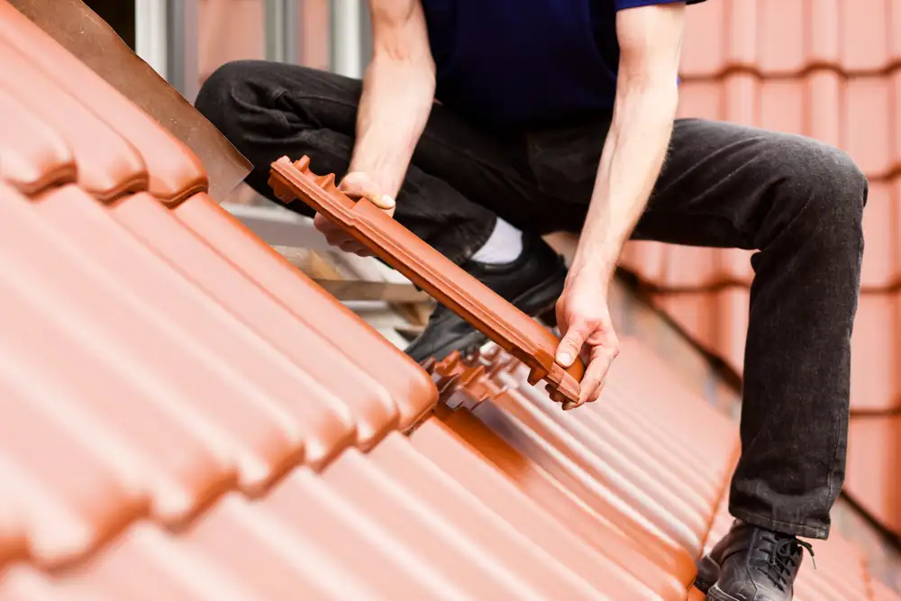 Roof tiles being installed on a roof